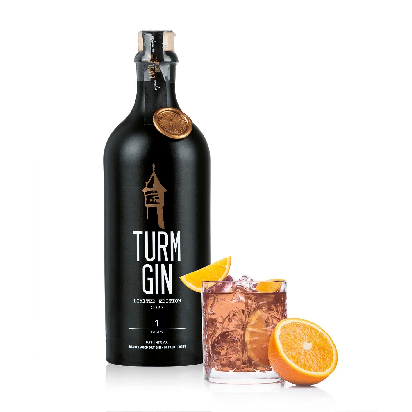 Schwarze Flasche TURM GIN Limited Edition 2023 mit Turmsiegel, daneben ein Cocktail mit Orangen vor weißem Hintergrund.